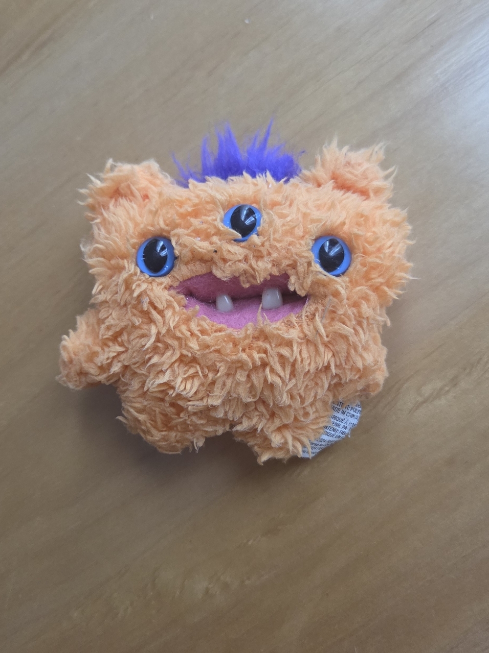 Plush Three-Eyed Orange Monster with Purple Hair - Cute Cuddly Toy